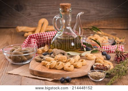 Italian taralli with spices on cutting board.