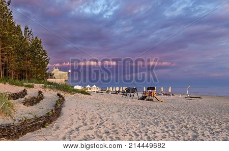 Colorful sunrise at sandy beach of the Jurmala - famous international Baltic resort in Latvia, Europe. Concept of summer resting and recreation activities