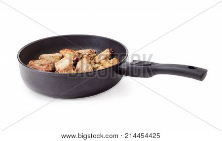 Fried pork ribs in the cast aluminium frying pan with ceramic non-stick coating on a white background