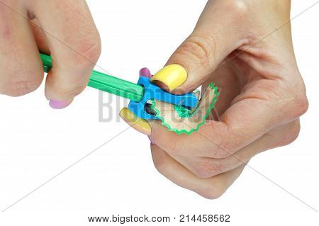 Hands with sharpener and pencil on an isolated background