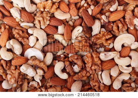 Natural background made from mixed walnut, almonds, cashew, cedar nuts