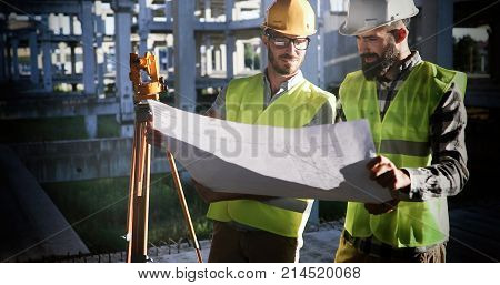 Portrait of construction engineers working on building site together
