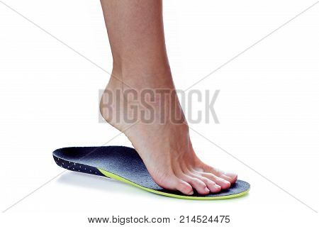 female foot stands on their toe in orthopedic insole