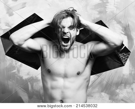 Caucasian Bearded Sexy Macho Man Holding Red Packages Or Bags