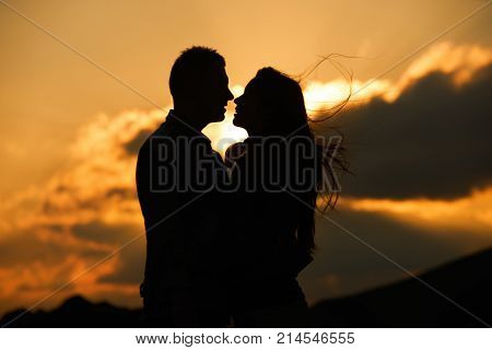 Kissing couple silhouette in the sunset sky. Allways together forever and Love concept. Feeling in love