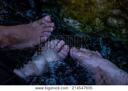 feet in the small waterpool with thermal water for enjoiying and medical therapy