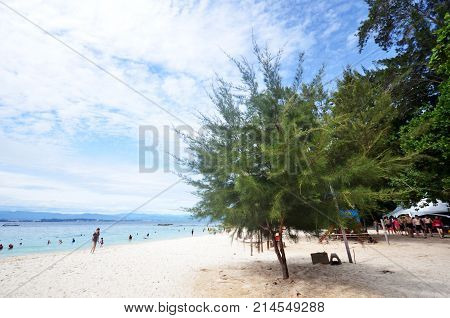 Tourists Enjoy White Sand Beach Of Sapi Island In Sabah