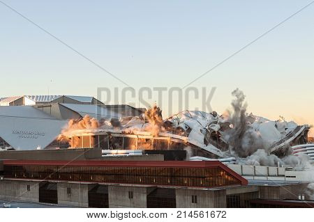ATLANTA, GA - NOVEMBER 2017: The massive structure of the Georgia Dome collapses during its implosion in the shadow of the new Mercedes-Benz Stadium in Atlanta GA on November 20 2017.