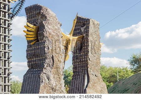 Kiev Ukraine October 08 2015: Fragment of central monument with bronze figure of stork soaring from stone vise and symbolizing rebirth of nation in National Museum Memorial to Holodomor victims