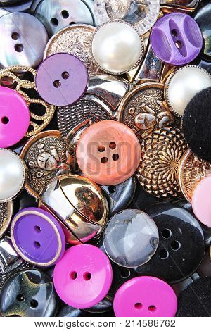 Buttons background. Colored shiny clothing button texture. Colored sewing buttons pattern concept wallpaper. Mixed colors. Studio photo texture photography. Colorful.