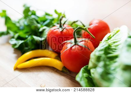 fresh ingredients for green salad on wooden kitchen table