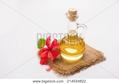 Jaswand or Hibiscus oil and bath soap/shampoo with flower and Reetha fruit and white towel