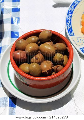 Green olives dish serve as an aperitif, snack.
