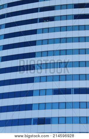 Picture of modern structure with windows and blue color background.