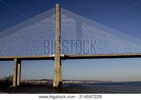 Panoramic photo of Vasco da Gama bridge in Lisbon on a sunny day.