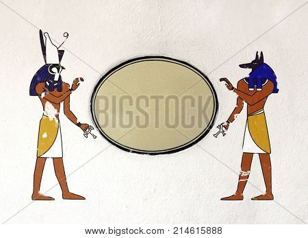 Grunge background with old stucco texture of light gray color, ceramic tablet and Egyptian gods Anubis and Horus images. Mock up tempalte. Copy space for your text