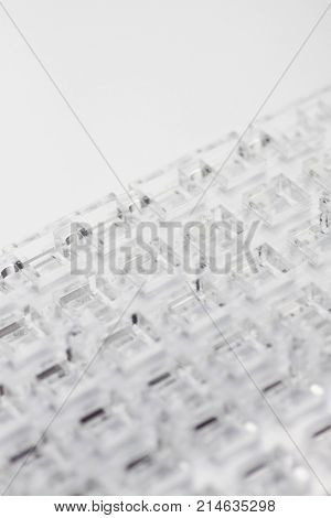 Abstract high-tech background. A sheet of transparent plastic or glass with the cut out holes. Laser cutting of plexiglass.