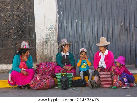 HUARAZ, PERU - JULY 27: Traditionally dressed peruvian people sell fruits and vegetables on the street market on July 27, 2017 in Huaraz, Peru.