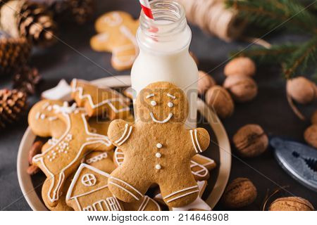 Milk and cookies. Gingerbread cookies on a gray background. Christmas cookies. Ginger men