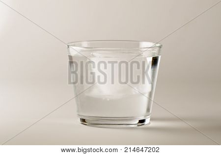 Physics. Ice cube floating in a glass of water.