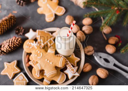 Milk and cookies. Gingerbread cookies on a gray background. Christmas cookies. Ginger men