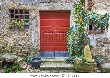 Red Entrance Door To A House On Stone Street In Istria, Croatia,