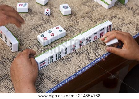 People playing mahjong on street, Yunnan China.