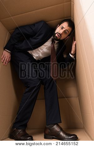 Businessman With Claustrophobia Inside A Box