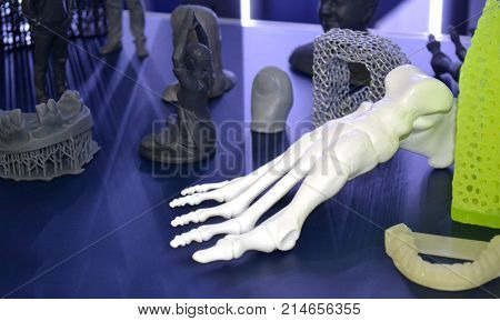 White prototype of the human foot skeleton printed on 3d printer on dark surface. Fused deposition modeling, FDM. Progressive modern additive technology. Concept of 4.0 industrial revolution