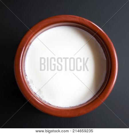 Homemade curd in clay pot made from cow milk. Sour cream or natural Cottage cheese