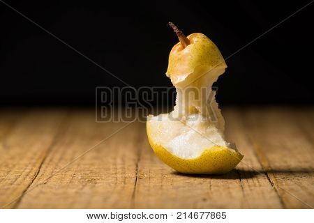 Pear bitten on an old wooden table