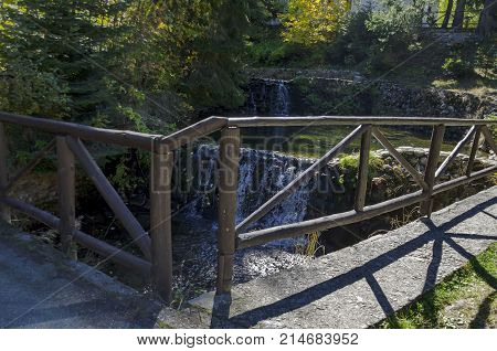 Old park Tsarska or Royal Bistritsa with terraced river, waterfall and differently trees in the venerable autumnal 
forest near by  resort  Borovets, Rila mountain, Bulgaria