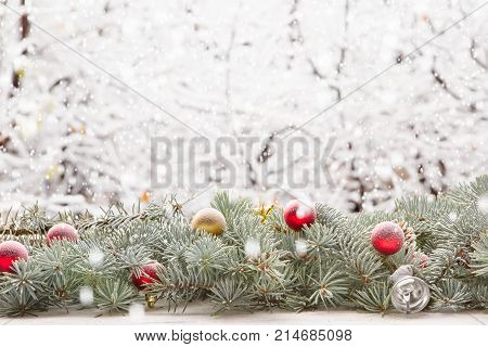 Christmas Fir Tree Garland On Wooden Board On Window Sill Over Nature Snowing Tree Park Background W