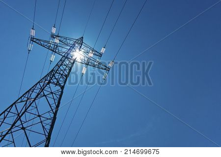 electricity pylon with sun and sky