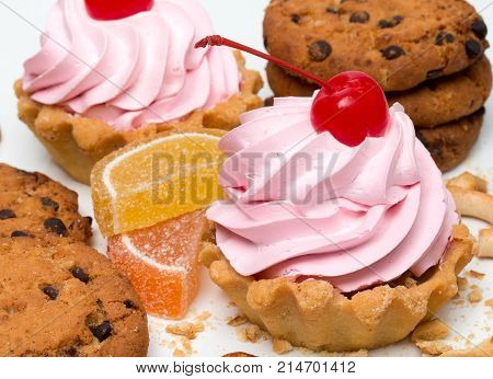 Delicious Cake With Cream And Cherry, Cookies With Chocolate, Slices Of Marmalade, Crumbs, Isolated