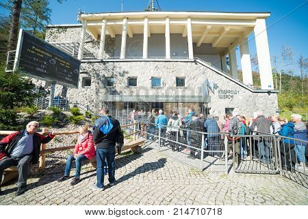 ZAKOPANE POLAND-SEPTEMBER 18: Cable car carries passengers from Zakopane to Kasprowy Wierch peak on Septomer 18 2017 in Zakopane Poland. a huge queue of people to the ticket office