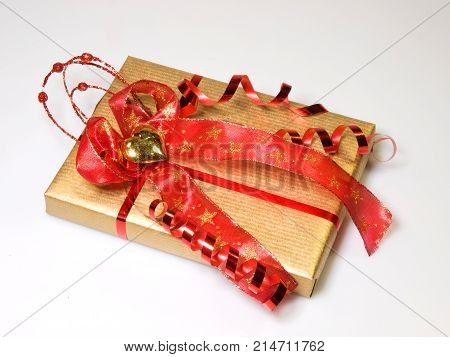 Present wrapped in gold and red decorate with gold heart