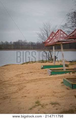 Beach Wooden Umbrellas On The Beach With A Red Roof.