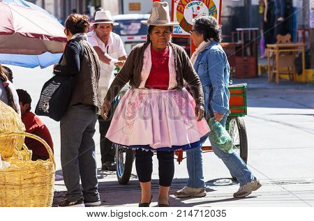 HUARAZ, PERU - JULY 27: Traditionally dressed peruvian people sell fruits and vegetables on the street market on July 27, 2017 in Huaraz, Peru.