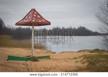 Beach Wooden Umbrellas On The Beach With A Red Roof.