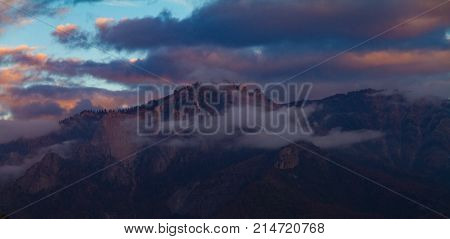 Moody foggy and stormy panoramic sunset view of Castle Rock in Sequoia National Park.