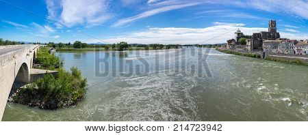 Saint Saturnin church and the medieval bridge over the Rhone river in Pont-Saint-Esprit France