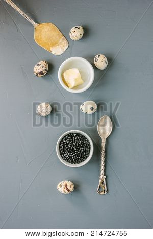 Top view of black caviar in white ceramic bowl
