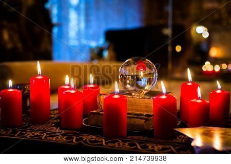 Crystal ball to prophesy or esoteric clairvoyance during a Seance in the candle light