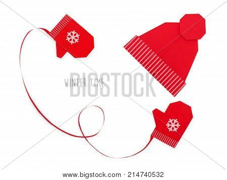 Origami red mitters and winter cap of paper on a white background