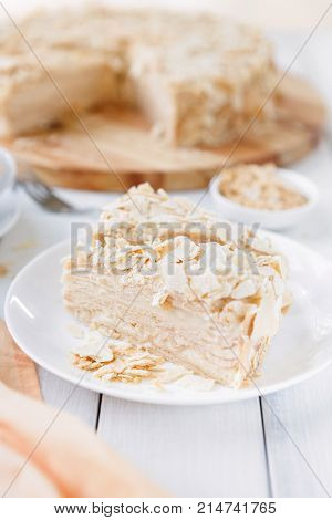 Portion of classic Napoleon cake closeup. Traditional millefeuille dessert with puff pastry and custard, russian cuisine treat, copy space