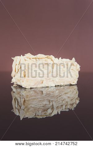 Portion of classic Napoleon cake on mirror table. Traditional millefeuille dessert with puff pastry and custard, russian cuisine treat, copy space