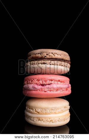 French colorful macaronstraditional almond cookies served on a black background close upmacro.