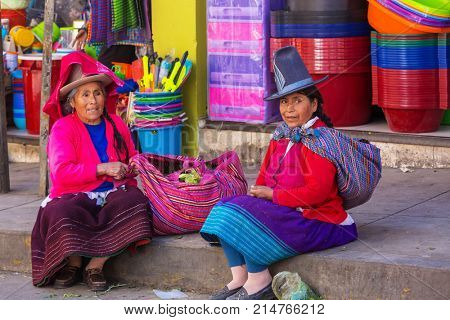 HUARAZ, PERU - JULY 27: Traditionally dressed peruvian people sell fruits and vegetables on the street market on July 27, 2017 in Huaraz, Peru.