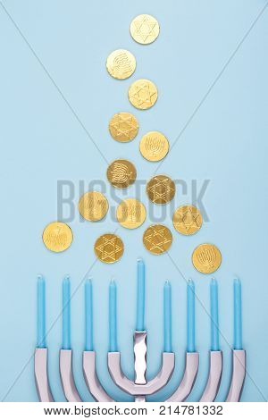 Blue Background With Menora And Chocolate Coins. Hanukkah And Judaic Holiday Concept.